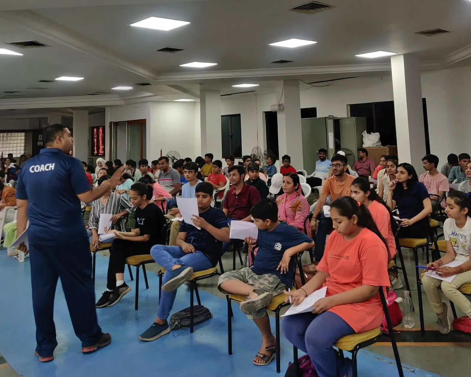 Coach briefing a school workshop