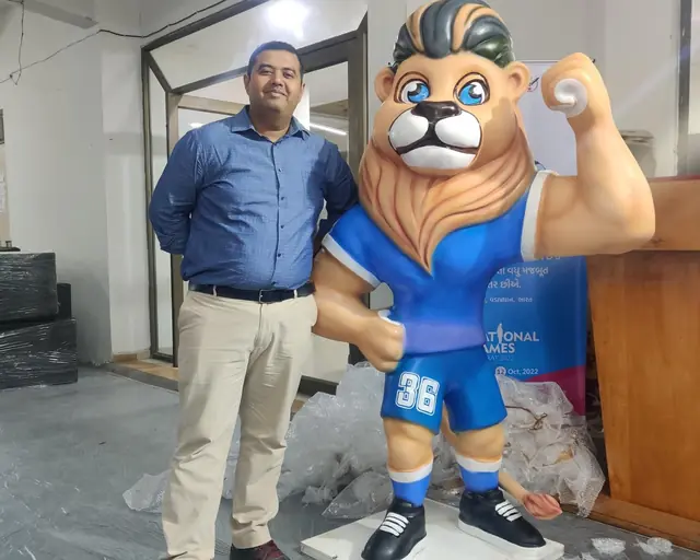 Coach Hardiksinh Rajput with the 36th National Games mascot